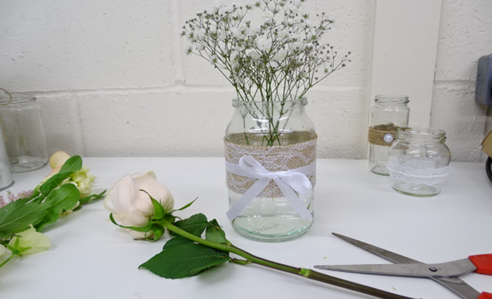 Next, add the rose to the arrangement. Simply, cut the stem to size and place into the jam jar. TOP TIP: The flowers will work out half of the overall height of the finished arrangement. 