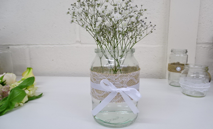 
                                                    Starting with the Gypsophila; here we are using just 1 stem in the jam jar. Divide the stem into equal pieces where they naturally branch and bunch together in the jam jar. This acts as a frame for the arrangement to guide the other flowers.