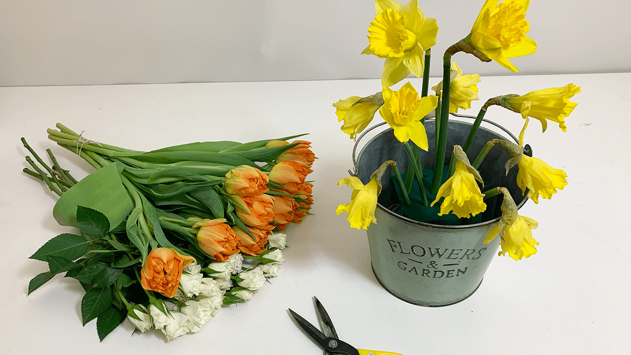 Start by adding the Daffodils into the arrangement. If the stems are too soft/weak to add into the floral foam, you can support the stem by adding a plant stick into the stem and inserting into the floral foam.
