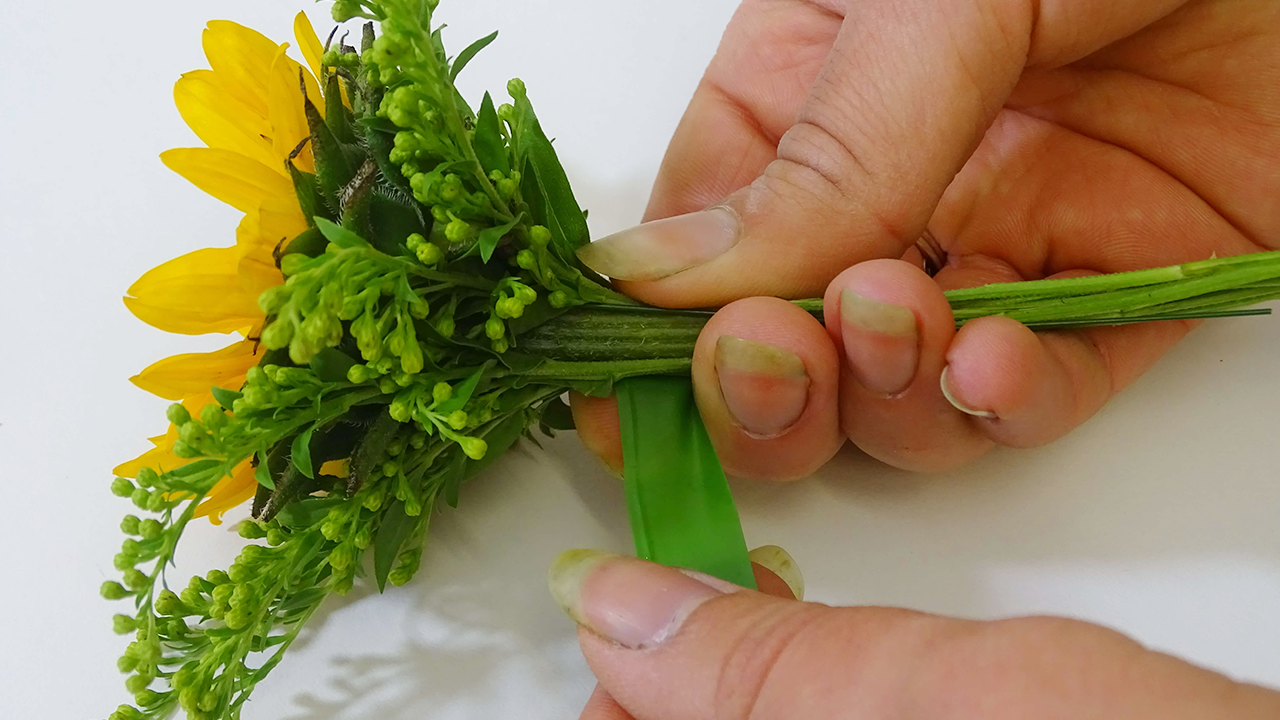 Once you are happy with the look, adding more or less solidago (personal preference), you will need to tape the components together with the parafilm (florist tape).