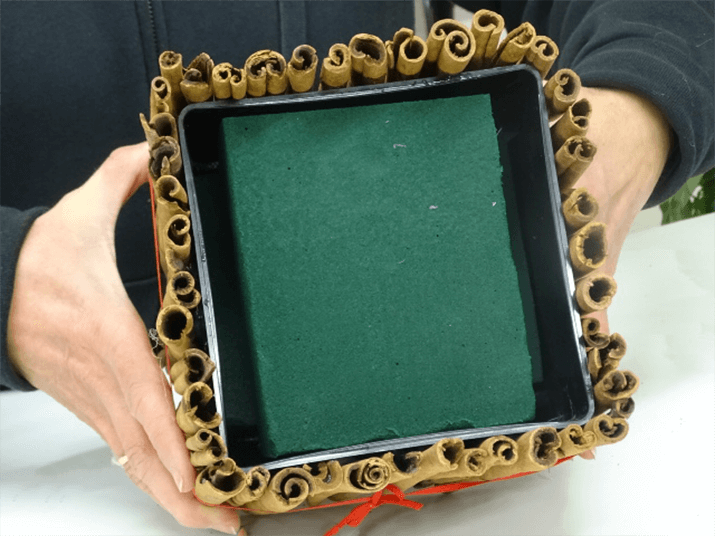 Measure the container and add a piece of soaked floral foam to the container as shown in the photograph.