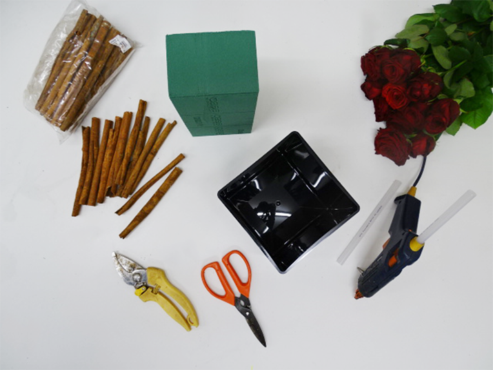
                                                    
                                                    Gather all of your equipment to start creating the design. Please see below in the shopping basket. As we are using Fresh flowers in the design, make sure you condition the roses before you start working with them. All the information on conditioning flowers is provided on the website. 
                                                Depending on the size of the container you will be using, you will need to work out how many roses you will need. Here, we are using 3x4 in a cube arrangement (total 12 roses). 