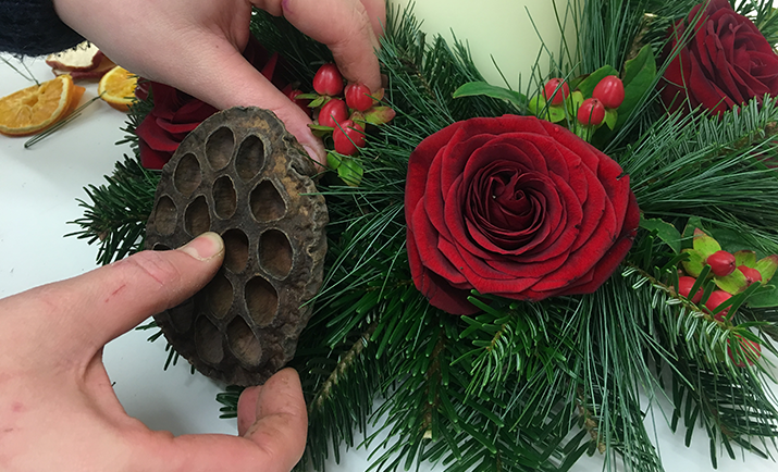 Add the hypericum and wired dried fruit and lotus heads to compliment the roses