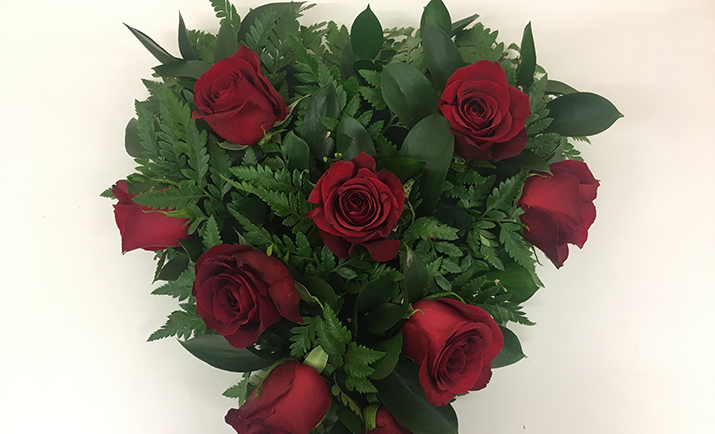 Start to arrange the roses or chosen focal flower into your arrangement. Depending on your personal preference, you can either make a contemporary design with grouped flowers or a more traditional design with evenly balanced flowers.