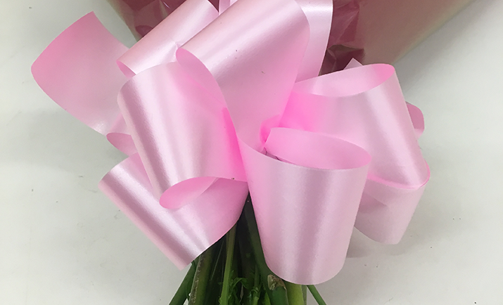 
                                                    Once you have finished, decorate the base of the bouquet with a bow. Here, we have created a Chocolate Box Bow made with Poly Ribbon. 

You can view How to Create a Chocolate Box Bow in the 'Florist Techniques' section. 
                                                